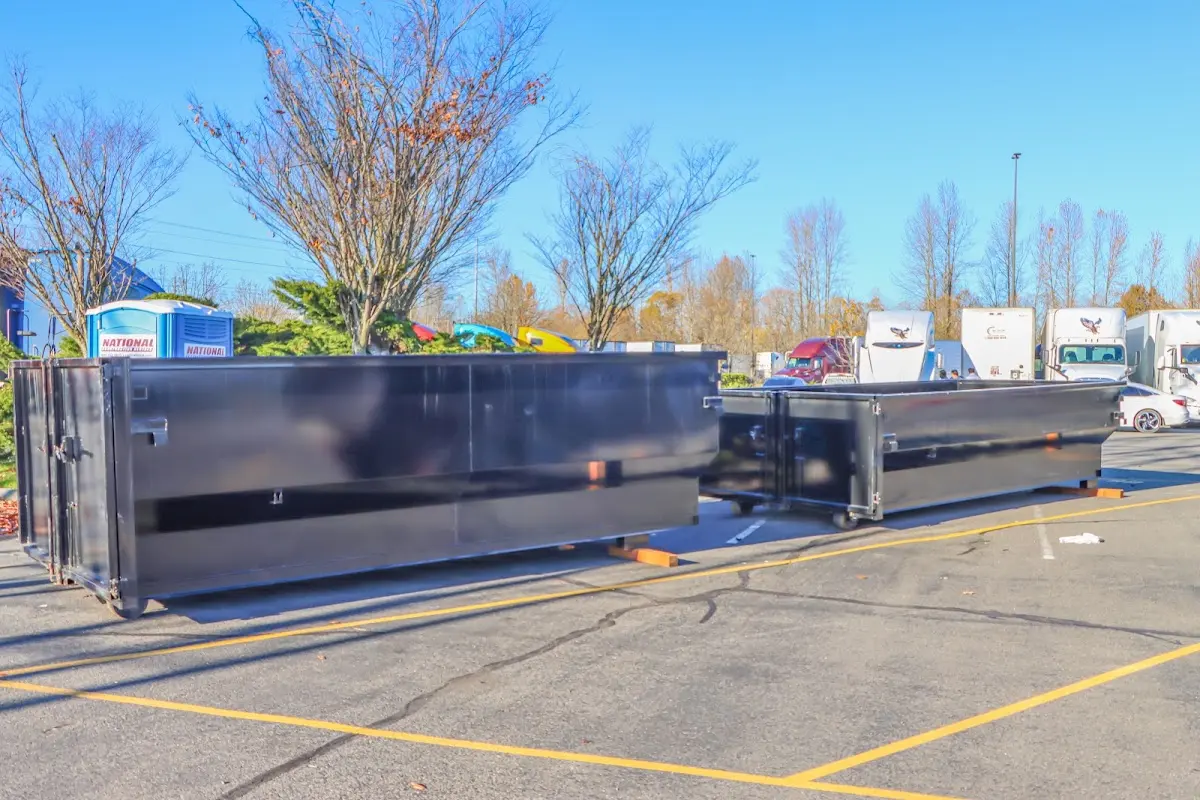 Professional dumpster rental service with roll-off container on residential driveway in Union Grove